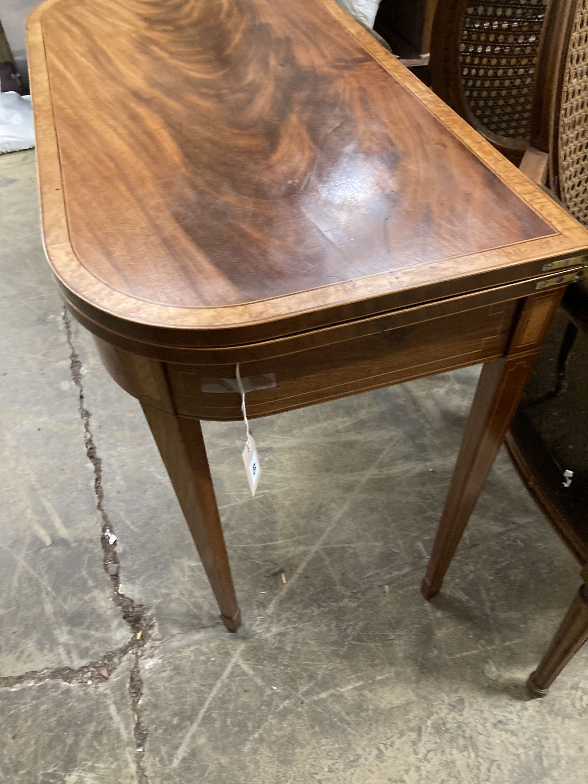 A George III bird's eye maple banded mahogany folding tea table, width 91cm, depth 46cm, height 75cm